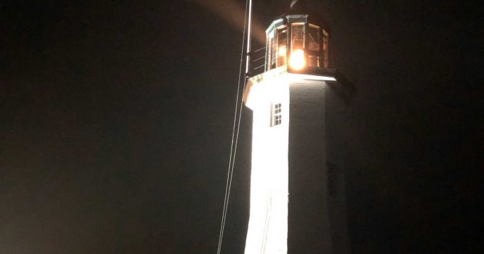 Old Scituate Light lit up at night in Scituate, Massachusetts